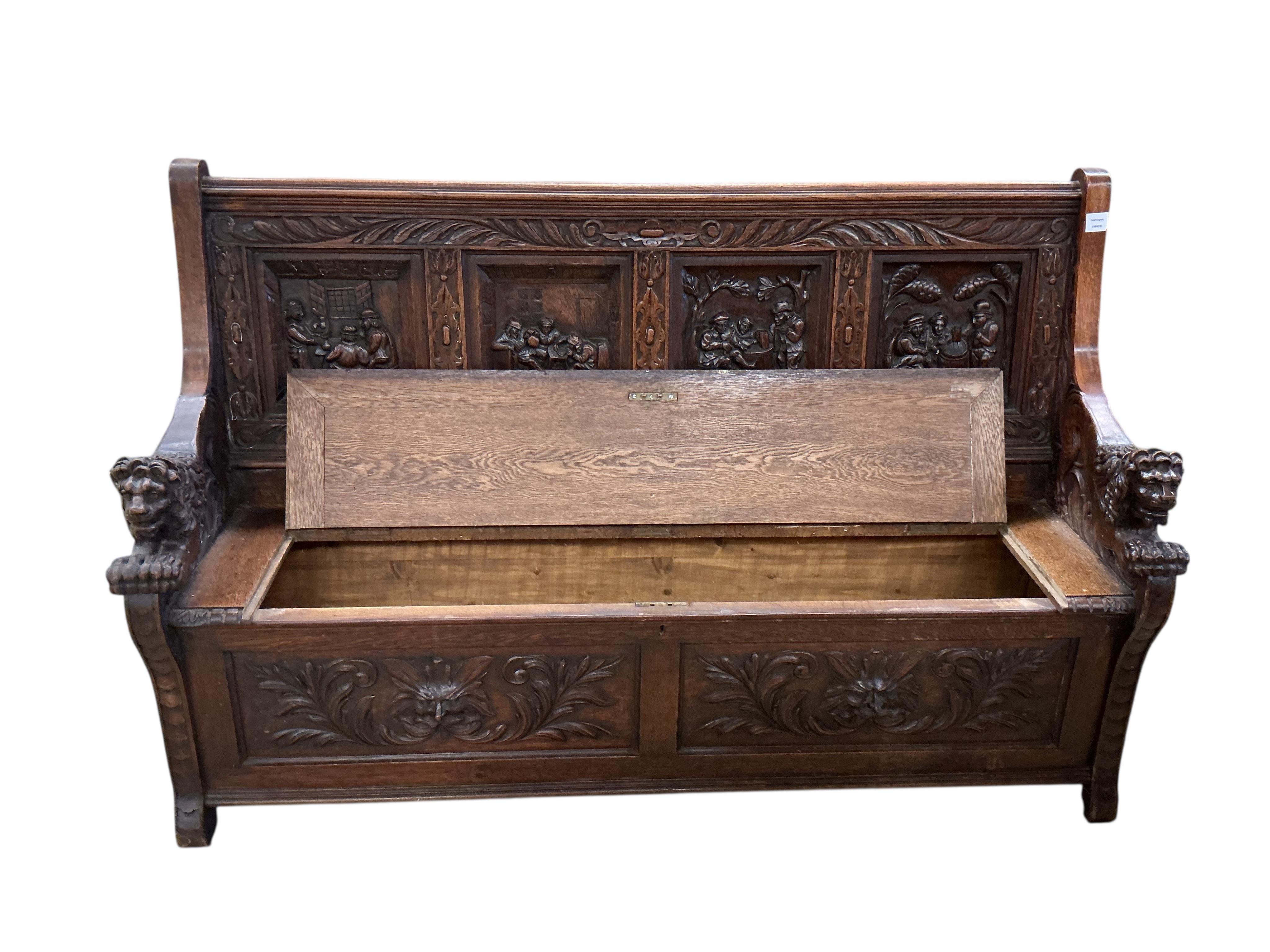 A late 19th century Flemish carved oak settle with hinged box seat, width 160cm, depth 42cm, height 106cm